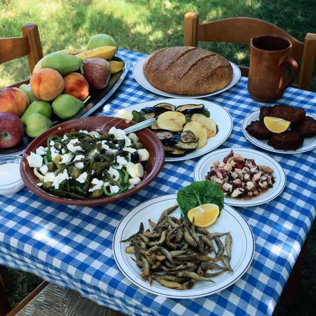 Picnic table loaded with Greek salad, crusty bread, eggplant, shrimp and other goodies.